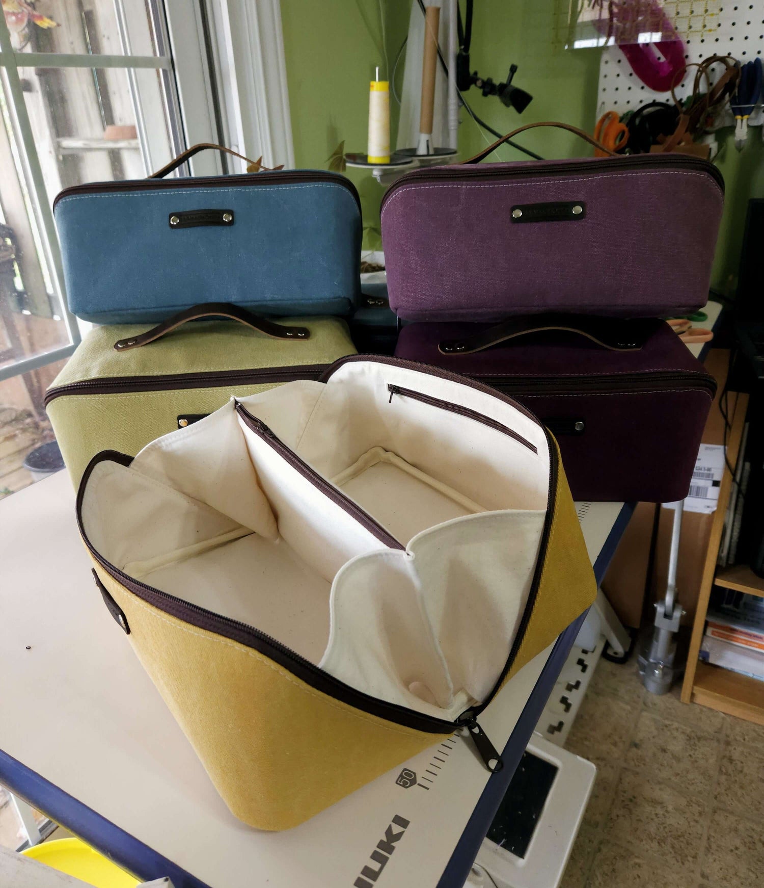 Zip N Go Project Bag Carry All in multiple colors, showcasing the spacious interior and organized compartments.